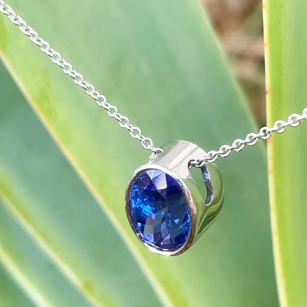 Luxuriously Suspended Slim Bezel Oval Tanzanite Pendant