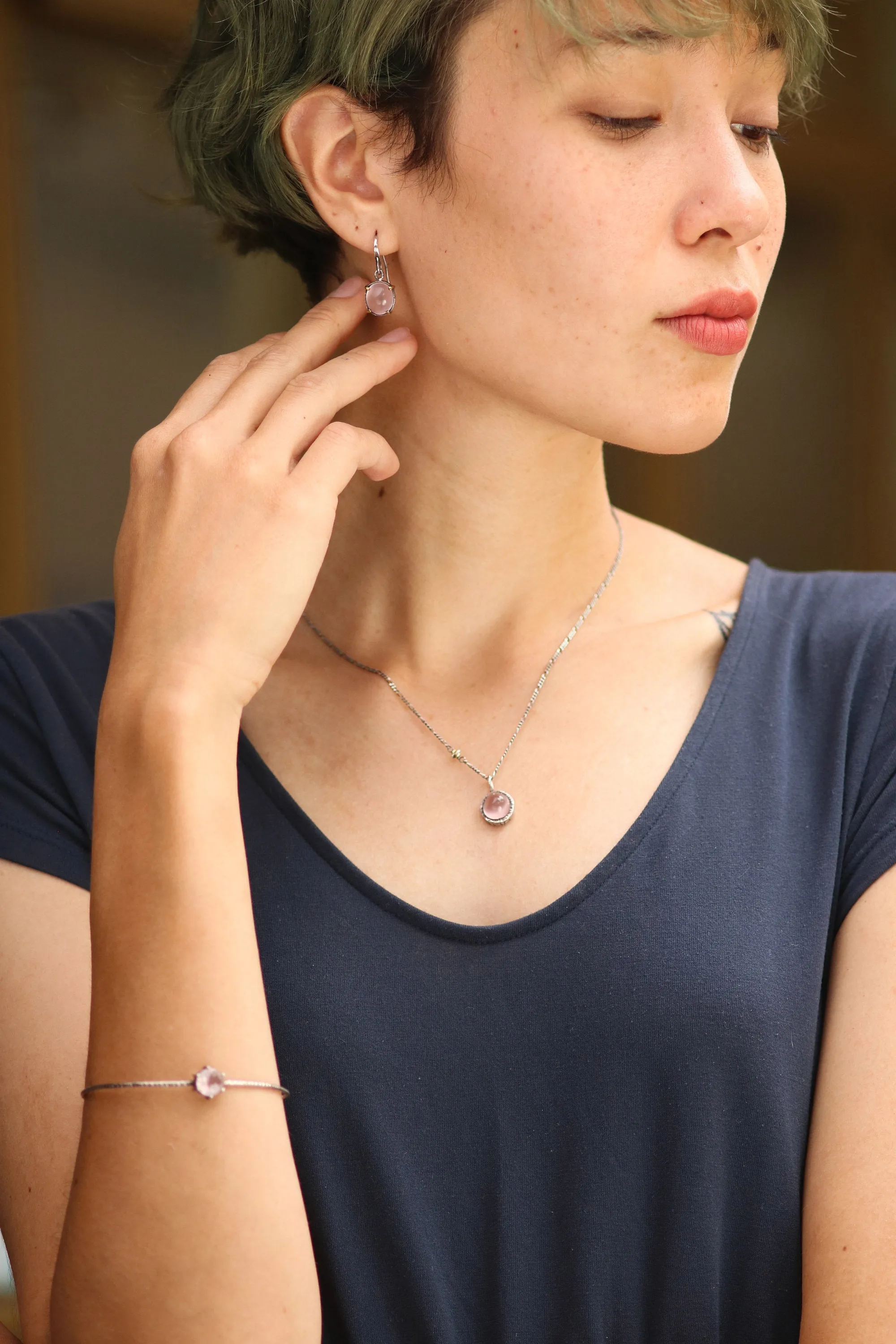 Oval cabochon Rose quartz earrings in silver bezel setting with polished brass accent prongs